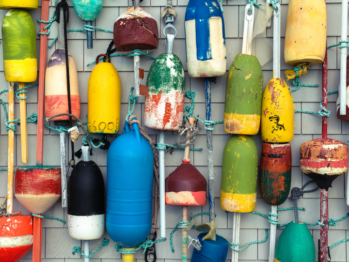 Wall covered in colorful lobster buoys